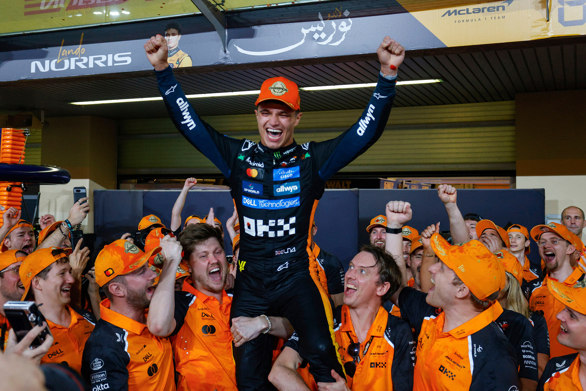 Lando Norris and the McLaren team celebrate in the pit lane after the British driver claimed his first Formula 1 world title at the Yas Marina Circuit in Abu Dhabi, UAE, December 7, 2025. /VCG