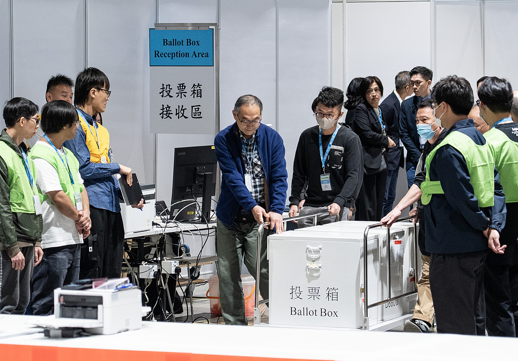 Staff members transported the first batch of ballot boxes for the Election Committee constituency to the central counting station located at the Hong Kong Convention and Exhibition Centre, December 7, 2025. /CFP