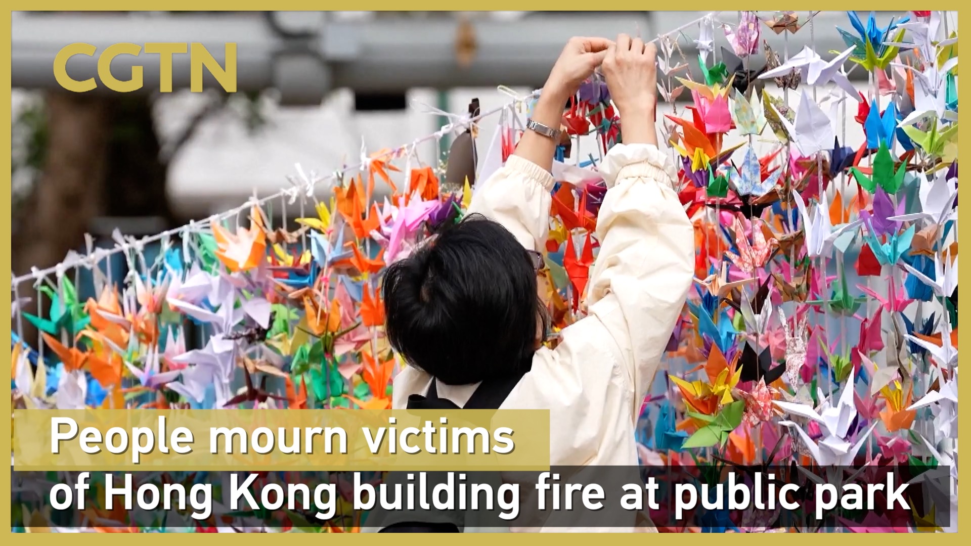 People mourn victims of Hong Kong building fire at public park