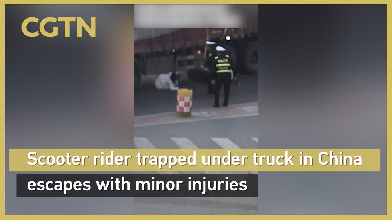 Scooter rider trapped under truck in China escapes with minor injuries ...