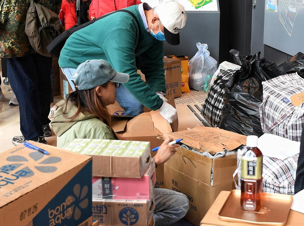 Staff members pack relief materials donated by citizens at a community in Tai Po of Hong Kong, south China, November 27, 2025. /Xinhua