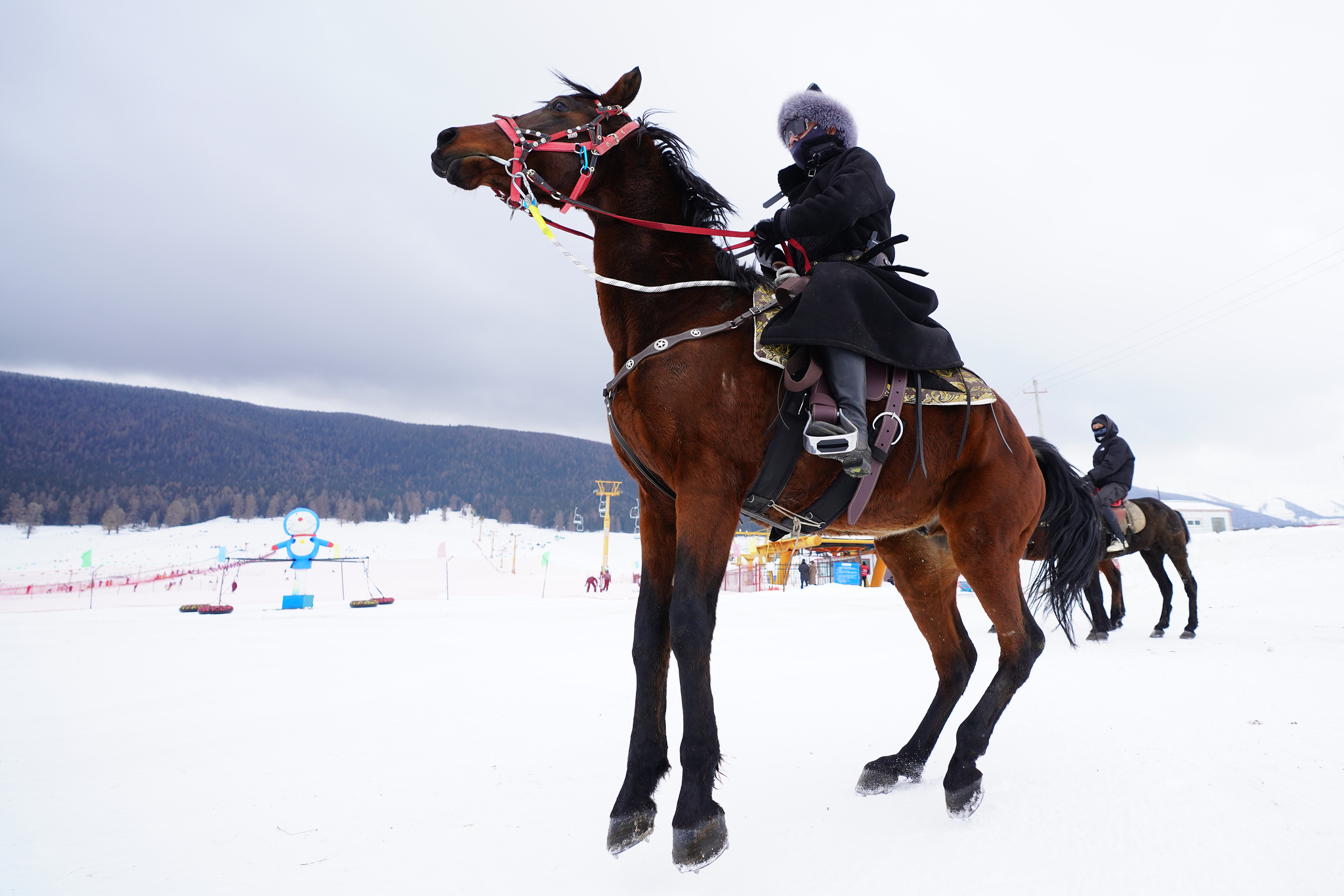 Visitors ride horses at the Songshutang Ski Resort in Hami, northwest China's Xinjiang Uygur Autonomous Region, on December 6, 2025. /VCG