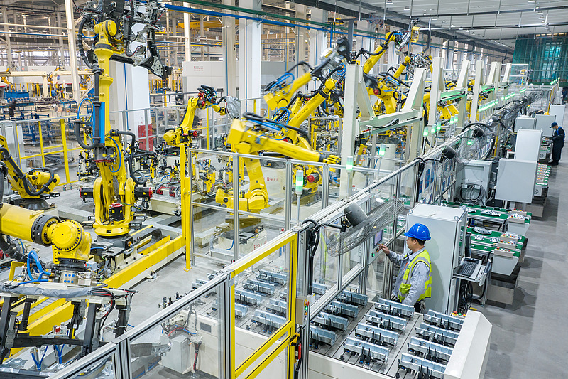 Robotic arms work on automated production lines, rushing to fulfill orders for new energy vehicle parts, in China's Huzhou, Zhejiang Province, December 11, 2025. /VCG