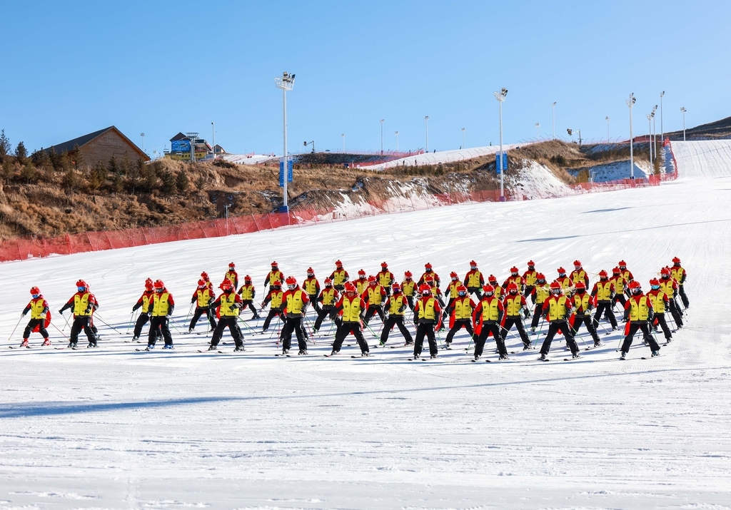 Ski coaches pose for photos at the Mazongshan Ski Resort in Hohhot, Inner Mongolia on December 7, 2025. /IC