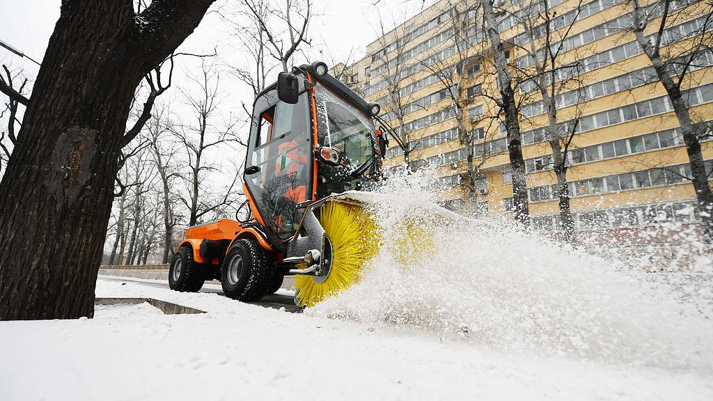 A snowplow clearing snow and ice on a street in Beijing, China, December 12, 2025. /VCG