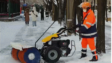 Staff using a snow sweeper to clear snow from a street in Beijing, December 13, 2025. /CGTN