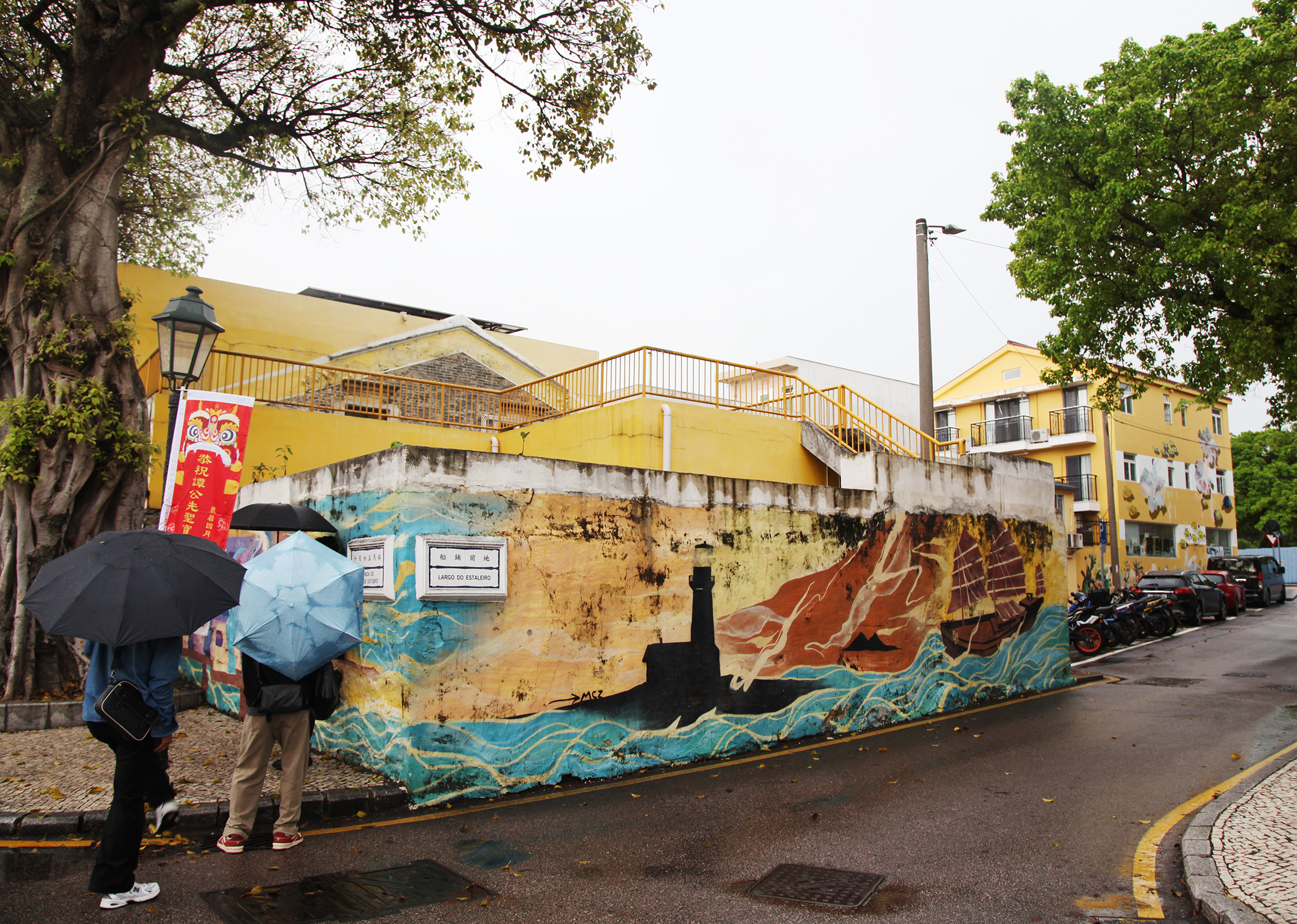 Visitors admire graffiti murals at Coloane Village in Macao. /CGTN