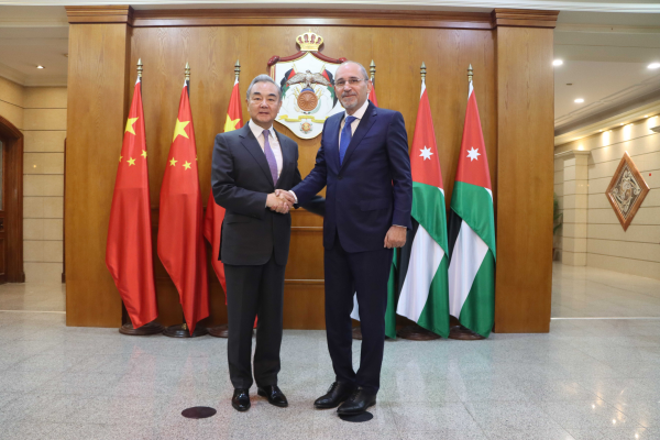 Chinese Foreign Minister Wang Yi (L), also a member of the Political Bureau of the Communist Party of China Central Committee, shakes hands with Ayman Safadi, deputy prime minister and minister of foreign affairs and expatriates of Jordan in Jordan, December 15, 2025. /Chinese Foreign Ministry