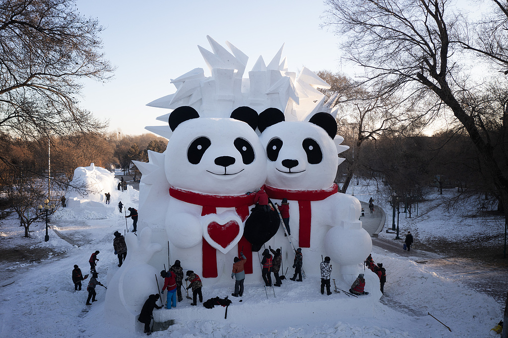 A pair of pandas sit at the front gate of the Harbin Sun Island International Snow Sculpture Art Expo in Heilongjiang, China, on December 12, 2025. /CFP
