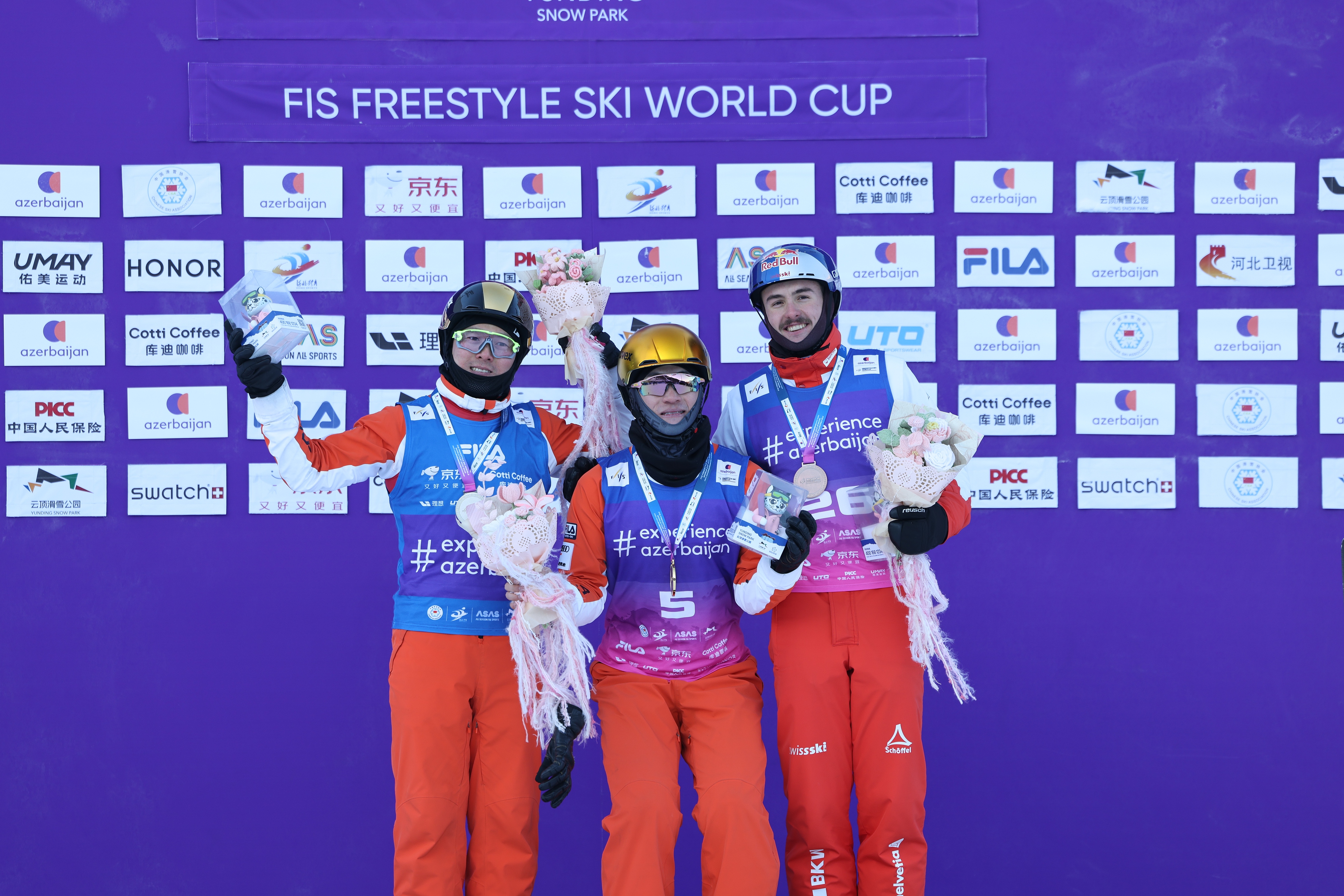 Li Tianma (C) celebrates after winning the gold medal in the men's aerials superfinal, with compatriot Qi Guangpu (L) taking silver while Switzerland's Noe Roth (R) claimed bronze, at the FIS Freestyle Ski World Cup in Zhangjiakou, China, December 20, 2025. /VCG