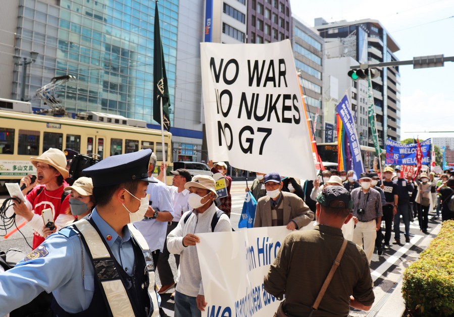 People hold a banner during a protest ahead of the Group of Seven Summit in Hiroshima, Japan, May 14, 2023. /Xinhua