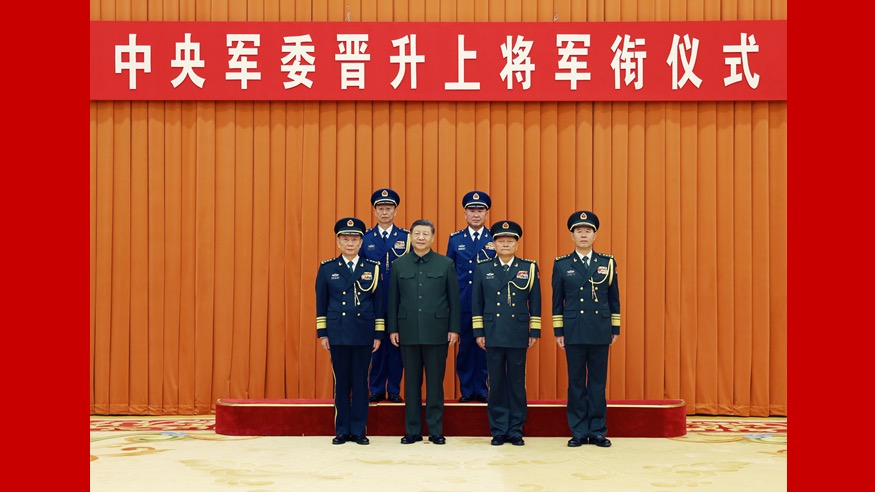 Xi Jinping, chairman of the Central Military Commission (CMC), and other leaders pose for a group photo with the promoted military officers in Beijing, capital of China, December 22, 2025. Xi on Monday presented certificates of order to promote two military officers to the rank of general. /Xinhua 