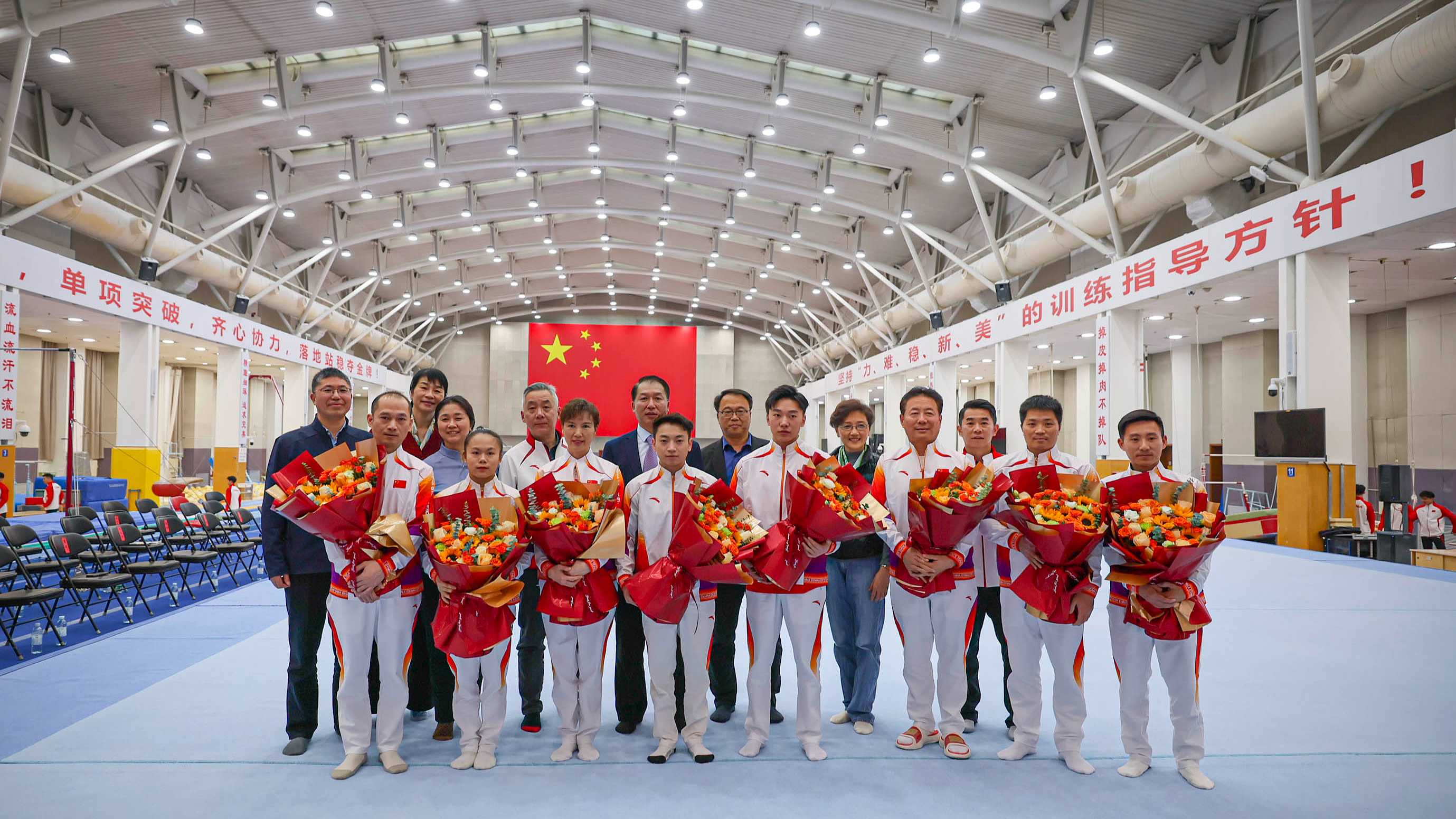 Athletes including Zhang Qingying and Zou Jingyuan pose for a photo during the 2025 World Champions Honoring Ceremony for Trampoline, Rhythmic Gymnastics and Artistic Gymnastics in Beijing on December 22, 2025. /VCG