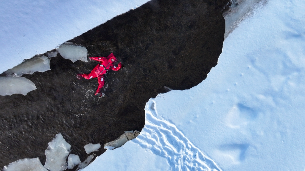 People wearing professional cold-protection suits experience ice floating on a river in Inner Mongolia, China, December 25, 2025. /IC