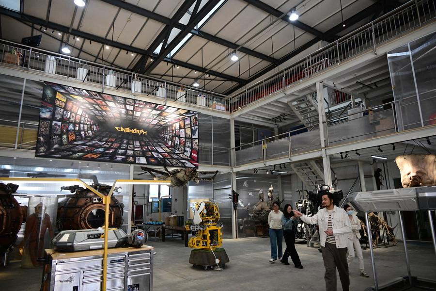 A staff member points out movie props at China Movie Metropolis in Qingdao, east China's Shandong Province, April 9, 2025. /Xinhua