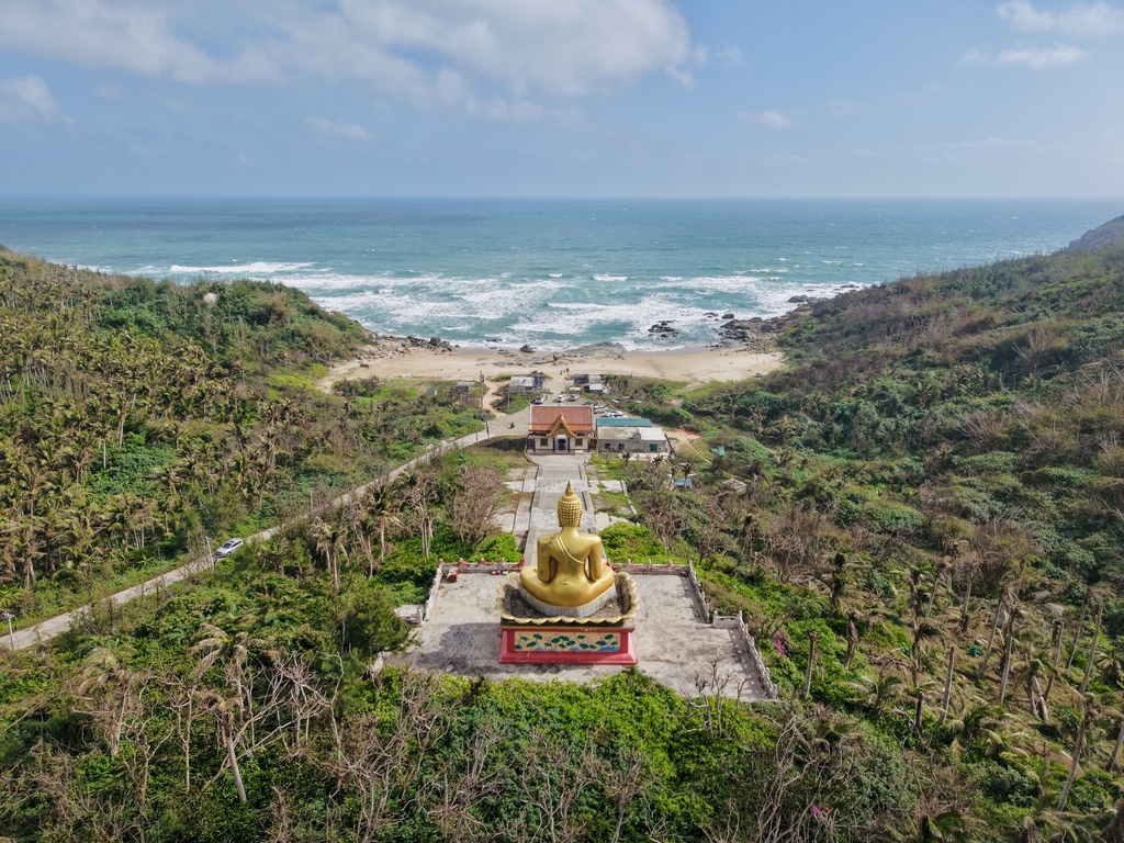 A 16-meter-tall statue of the Sakyamuni Buddha looks out to sea from the Foguang Temple in Wenchang, Hainan Province, China. /IC