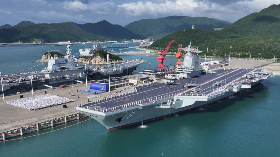 The commissioning and flag-presenting ceremony of the Fujian, China's first aircraft carrier equipped with electromagnetic catapults, is held at a naval port in Sanya, south China's Hainan Province, November 5, 2025. /Xinhua