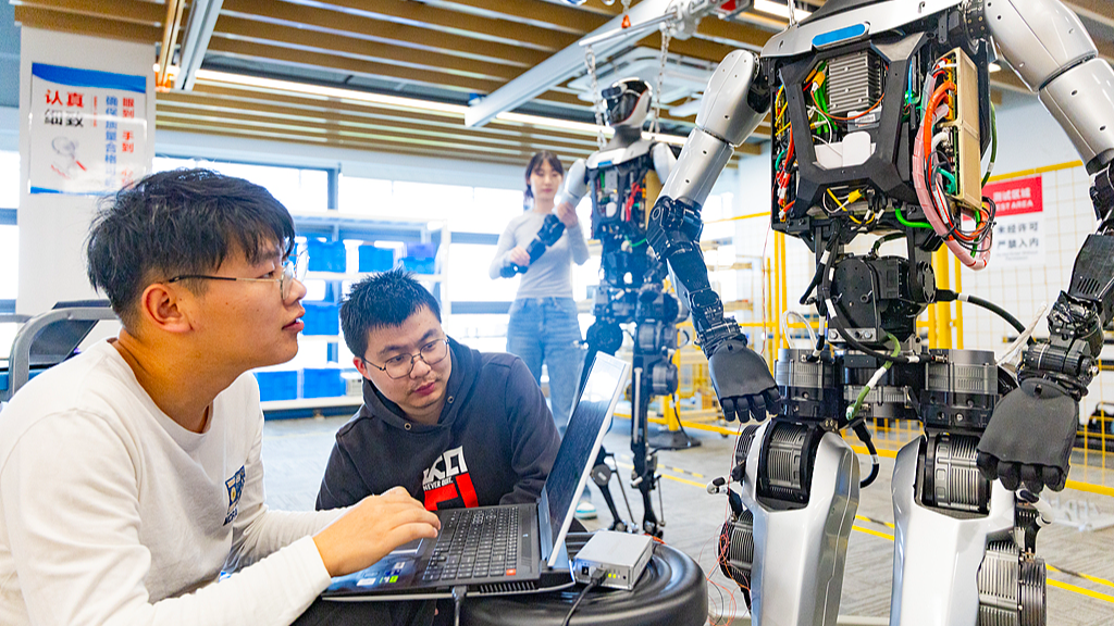 Researchers test the performance of a robot at a humanoid robot innovation center in east China's Shanghai, March 26, 2025. /VCG