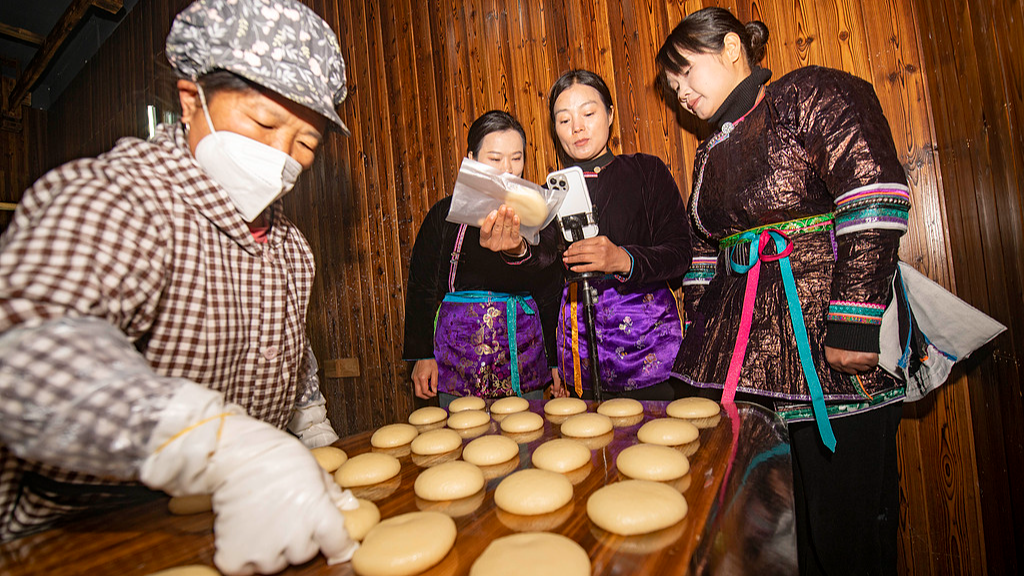 Residents of a Dong ethnic village in Guizhou Province demonstrate how to make ciba through e-commerce livestreams, attracting orders from across China, December 25, 2025. /VCG