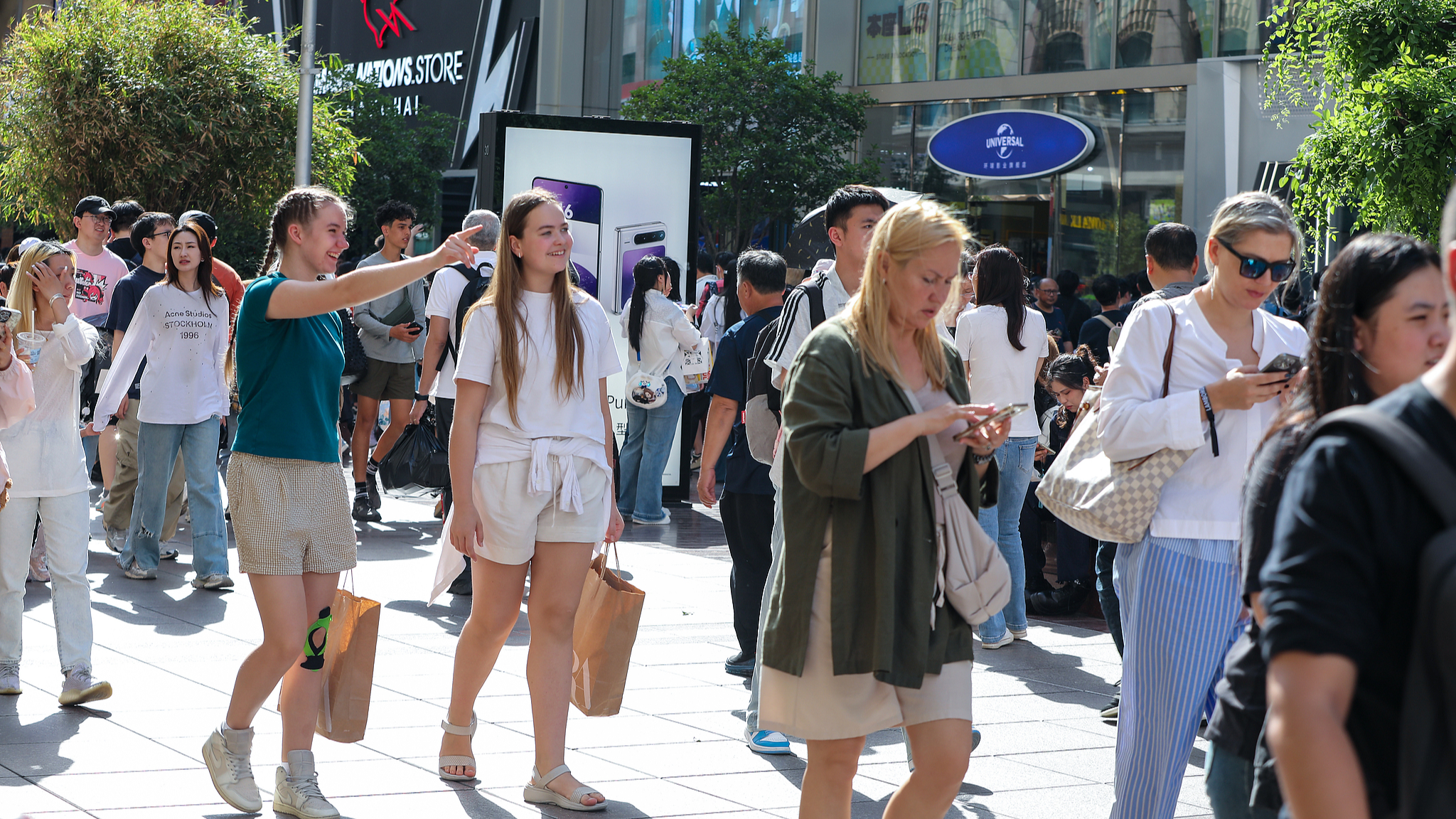 Tourists from home and abroad explore the Nanjing Road Pedestrian Street in Shanghai, east China, May 1, 2025. /CFP