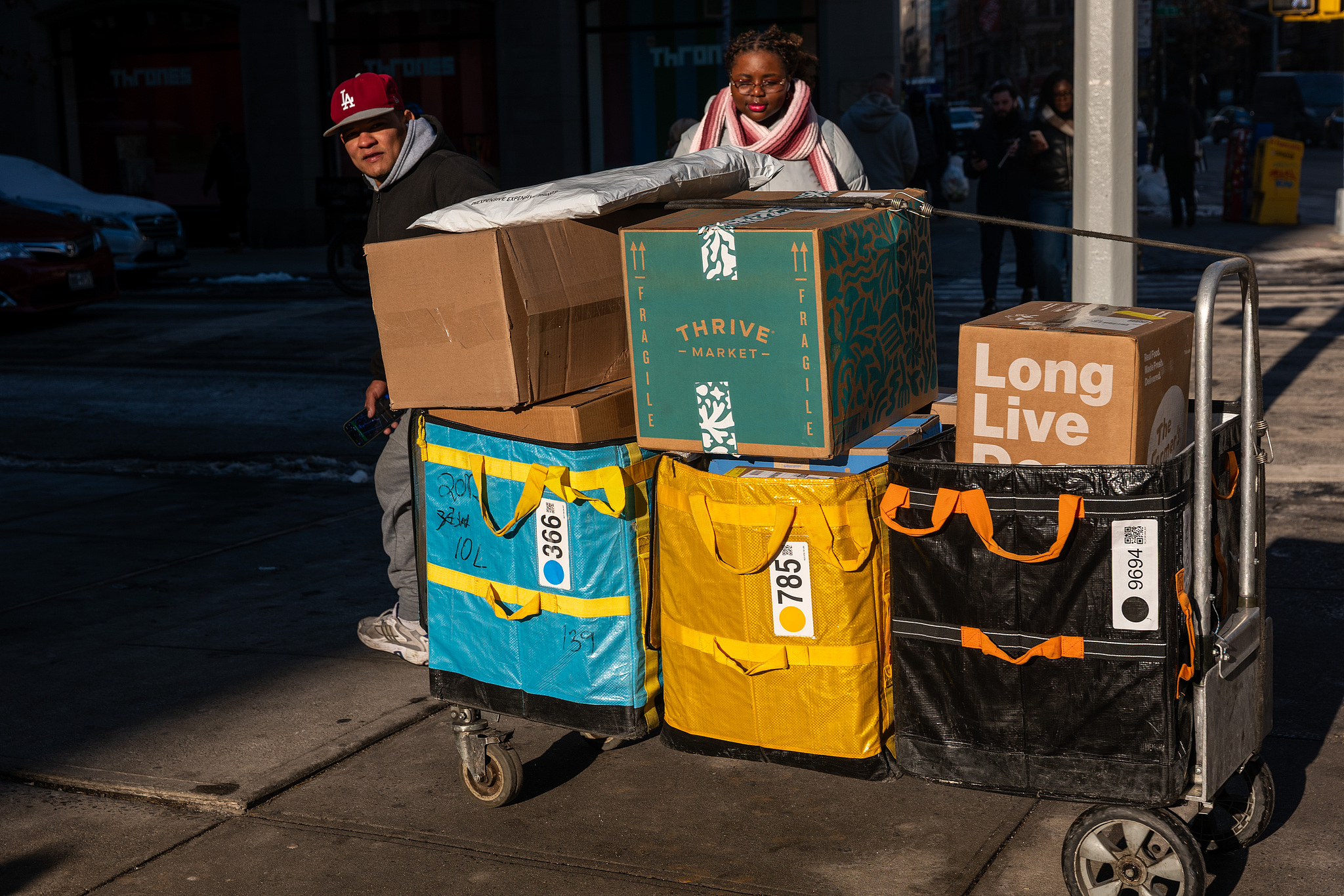 A man makes deliveries in New York City, US, December 16, 2025. / VCG