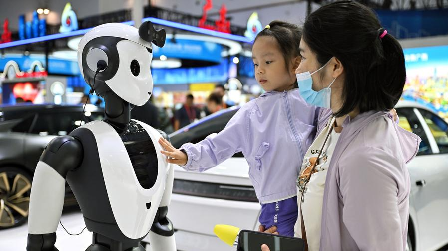 A child interacts with a robot at the fourth China International Consumer Products Expo in Haikou, capital city of Hainan Province in south China, April 15, 2024. /Xinhua