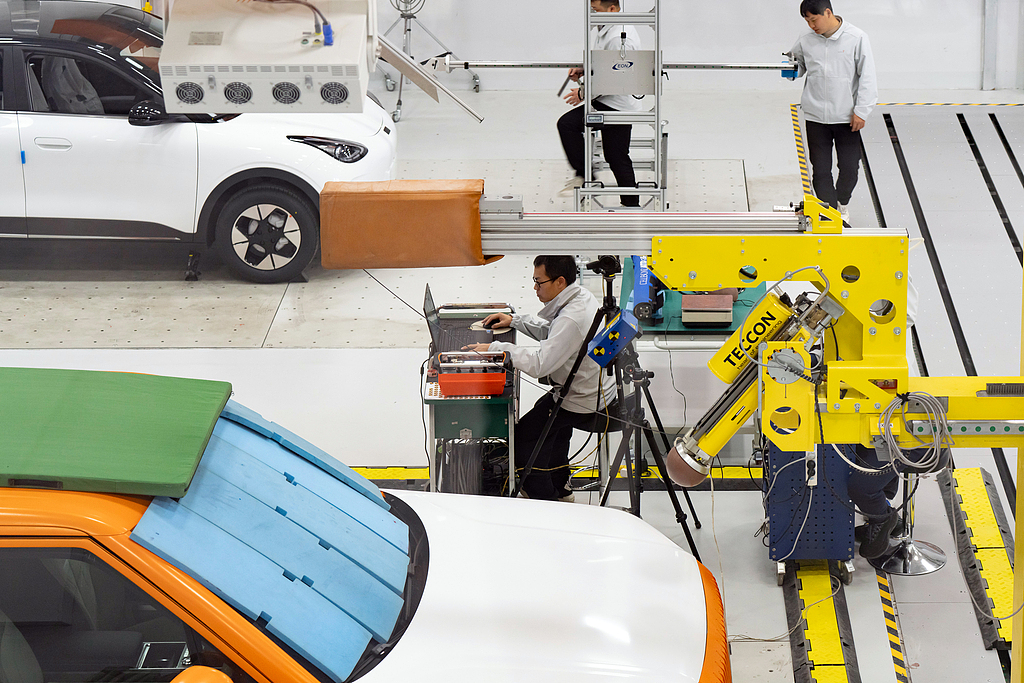 Workers conduct vehicle assessments in an automotive safety testing center in Ningbo, Zhejiang Province, China, December 12, 2025. /VCG