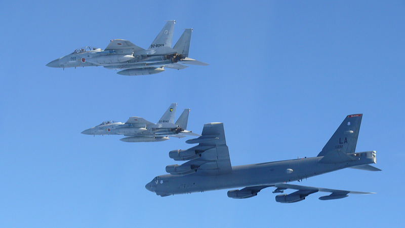 The Japan Air Self-Defense Force's F-15 fighters holding a joint military drill with the U.S. B-52 bomber in the vicinity of Japanese airspace, December 10, 2025. /Xinhua