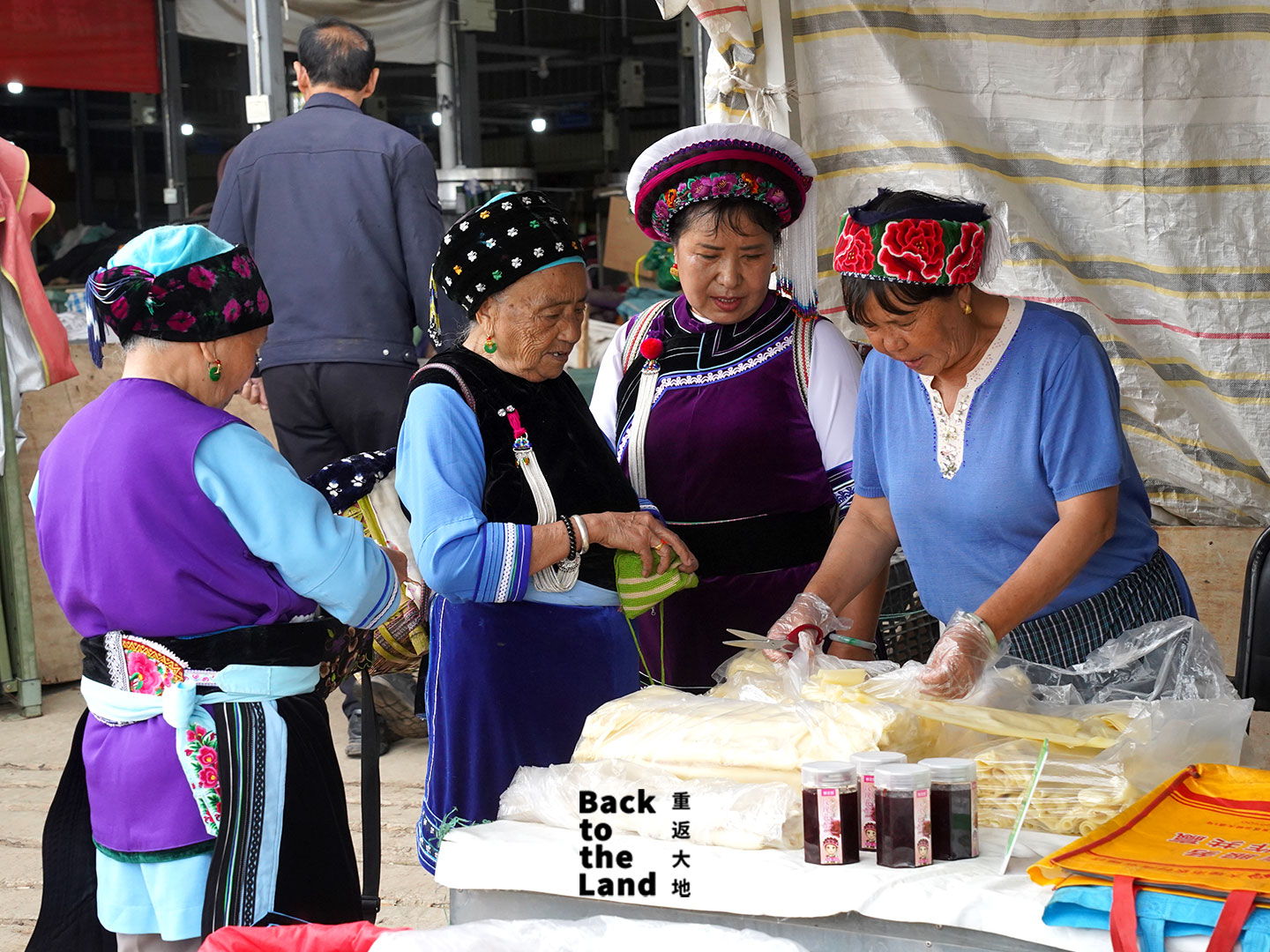 A lively morning market scene in Dali featuring local Bai grandmothers selling fresh seasonal produce and traditional ingredients. /CGTN