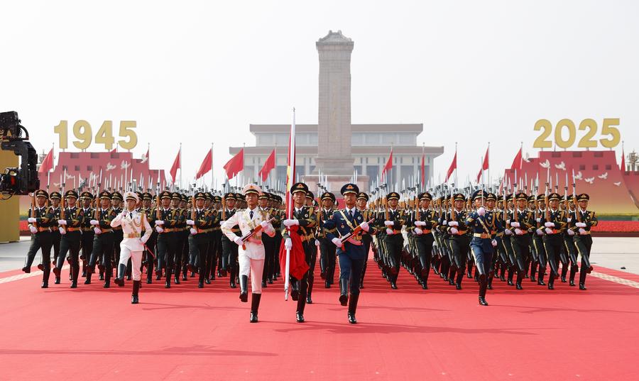 Honor guard escort the Chinese national flag for a flag-raising ceremony during a grand gathering to commemorate the 80th anniversary of the victory in the Chinese People's War of Resistance Against Japanese Aggression and the World Anti-Fascist War in Beijing, capital of China, September 3, 2025. /Xinhua