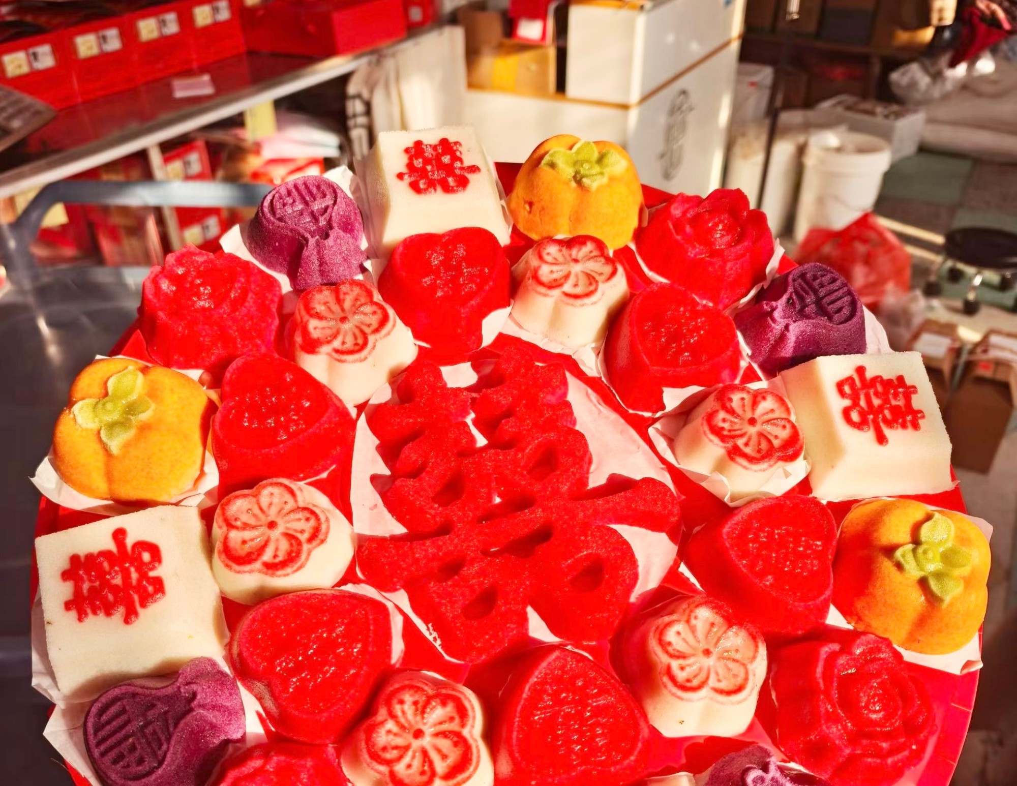 Handmade rice cakes shaped like ingots, peaches, persimmons and other auspicious symbols are seen on display at a village pastry shop in Changzhou, Jiangsu Province, December 31, 2025. /VCG