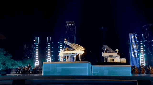 A humanoid robot plays the piano with human musician. /CMG