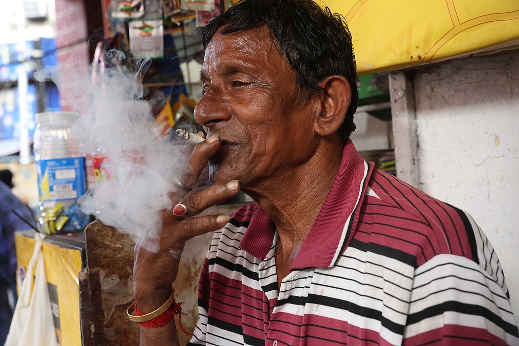 A man smokes a cigarette at a tobacco shop in Kolkata, India, September 4, 2025. /CFP