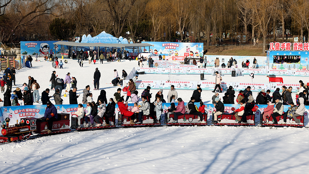 People enjoy ice and snow at a park in Beijing, China, January 2, 2025. /VCG