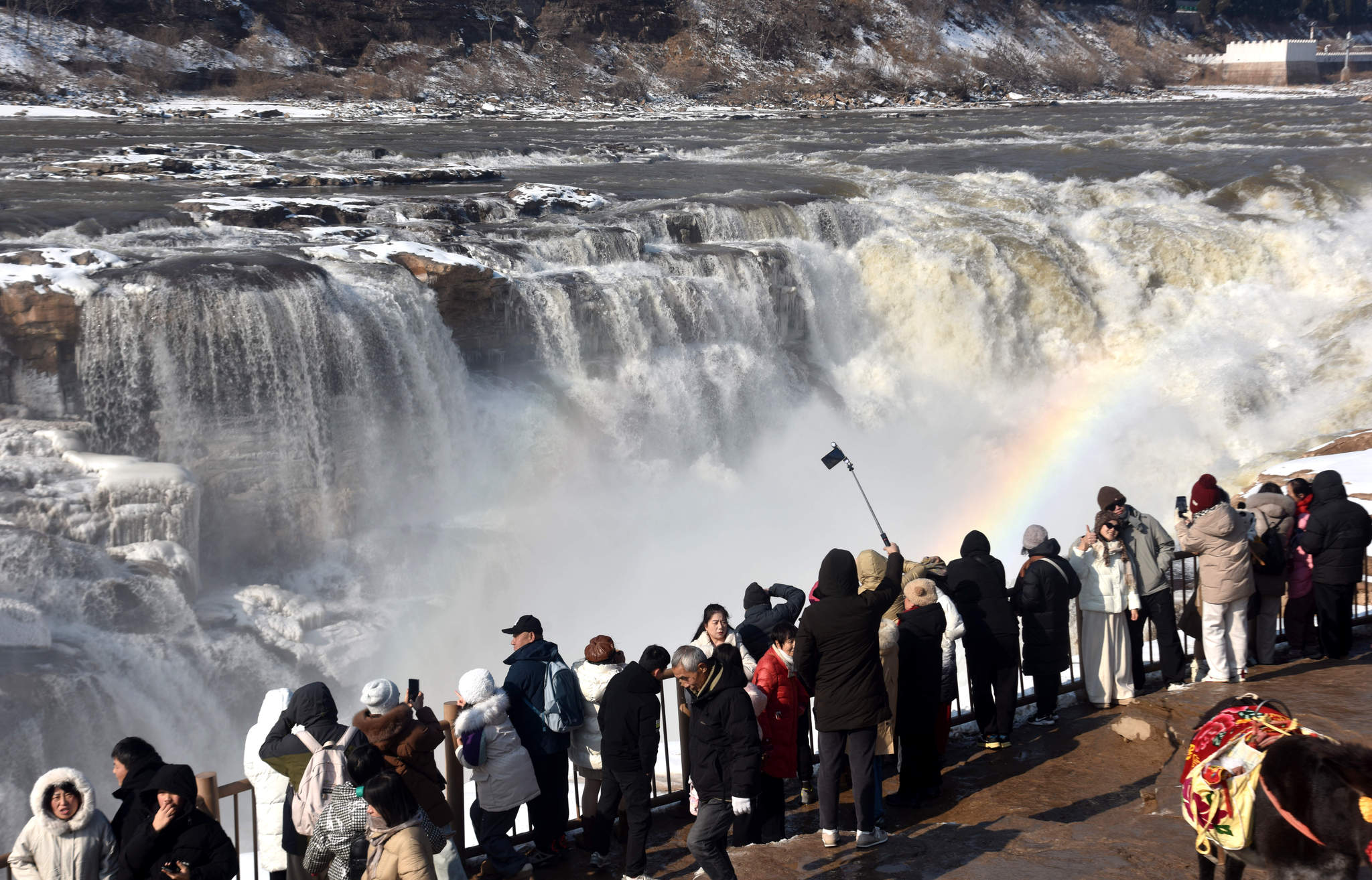 Visitors admire Hukou Waterfall in Jixian County, Shanxi Province on January 2, 2026. /VCG 