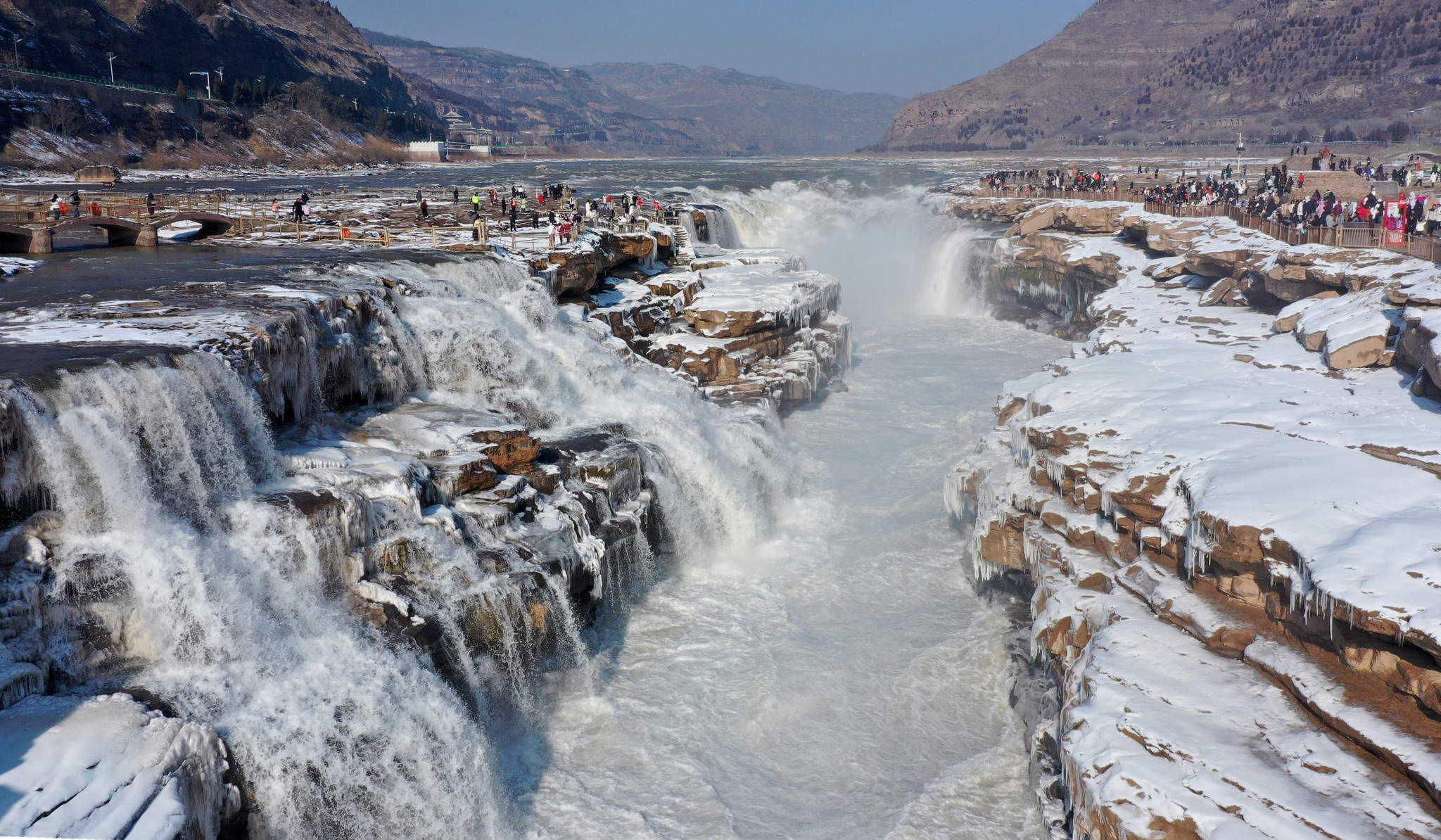 Visitors admire Hukou Waterfall in Jixian County, Shanxi Province on January 2, 2026. /VCG 