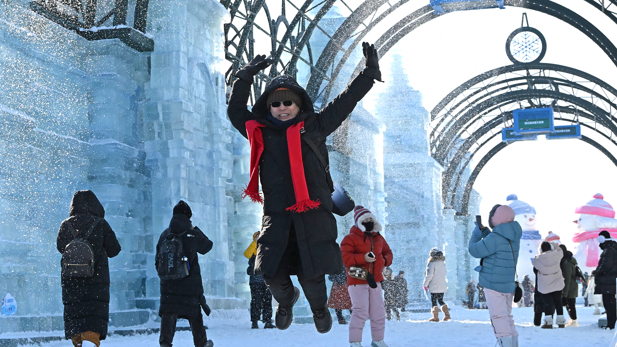 Tourists happily enjoy themselves and take photos in the Ice-Snow World, Harbin, Heilongjiang Province, northeast China, January 5, 2026. /VCG