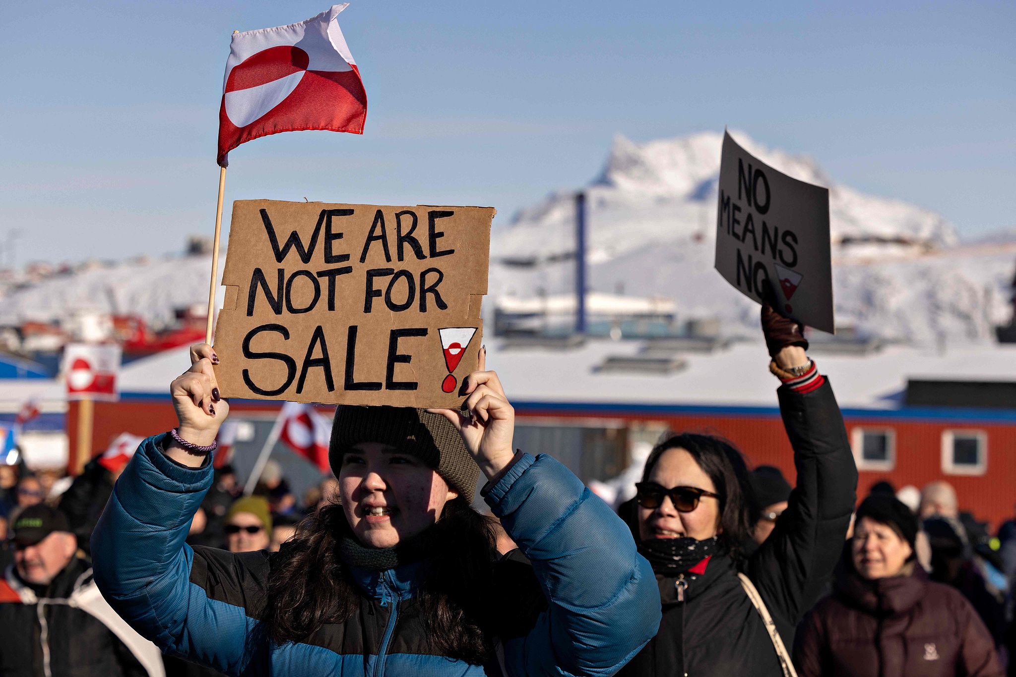 A protester holds a sign reading 