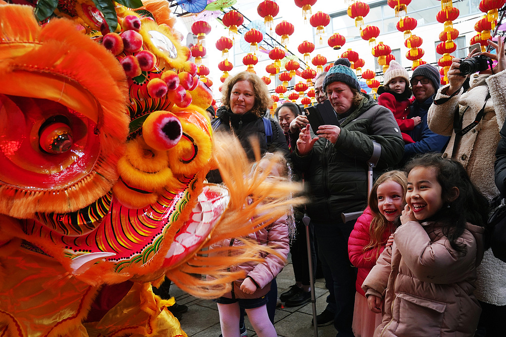 A file photo from 2023 shows a lion-dance performance in Dublin's city center as part of Spring Festival celebrations. Chinese New Year celebrations have been held in the Irish capital for 18 consecutive years, with major landmarks and bridges along the River Liffey lit up in red. /VCG
