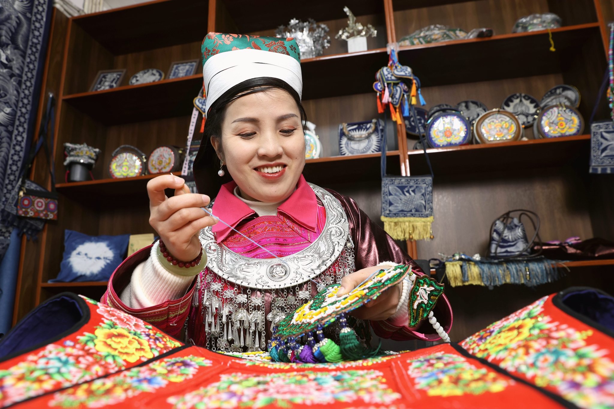 A live-streamer demonstrates ethnic embroidery techniques to online viewers in Rongjiang County, Qiandongnan Miao and Dong Autonomous Prefecture, in southwest China's Guizhou Province on January 7, 2026. /VCG