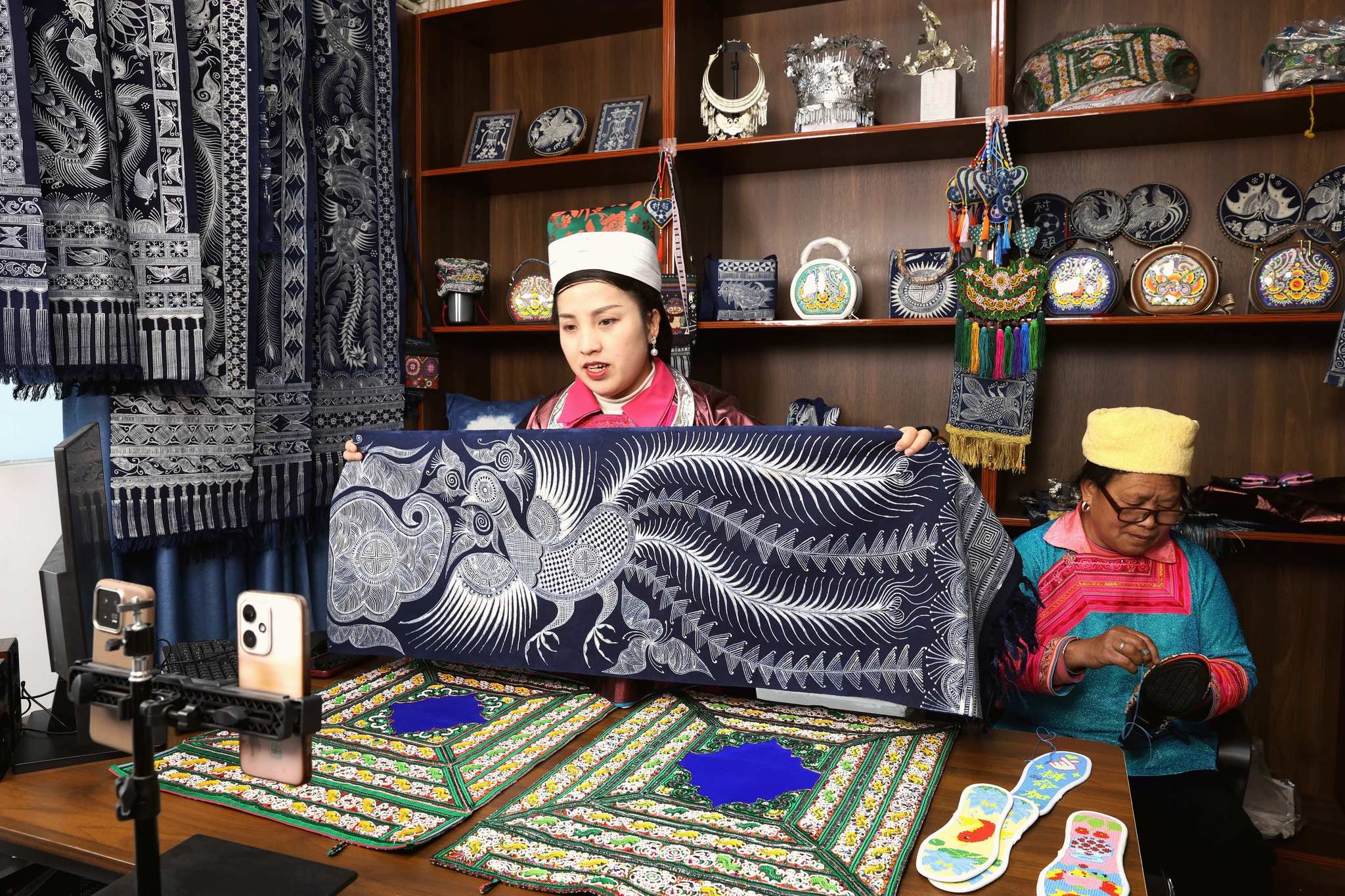 A live-streamer showcases ethnic wax printing pieces to online viewers in Rongjiang County, Qiandongnan Miao and Dong Autonomous Prefecture, in southwest China's Guizhou Province on January 7, 2026. /VCG