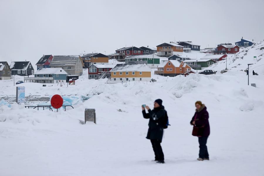A man takes photos in Nuuk, capital of Greenland, March 19, 2025. /Xinhua