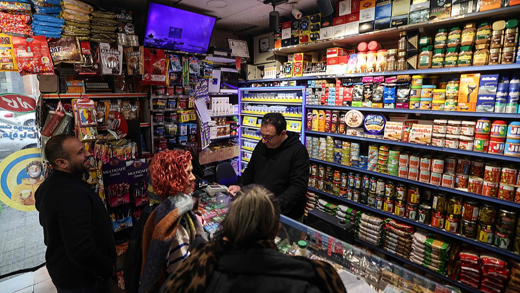 A shop owner serves customers at a store in Tehran, Iran, January 7, 2026. /VCG