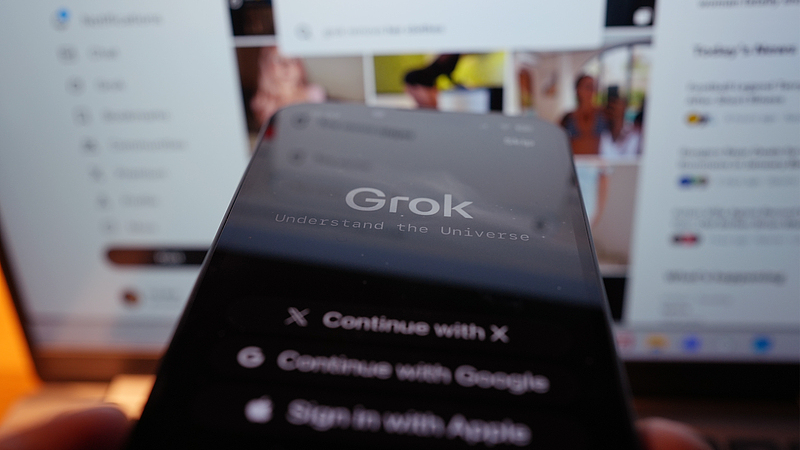 The Grok app on an iPhone, against the backdrop of search results displayed on the social media platform X (formerly Twitter) on a laptop, in London. /VCG