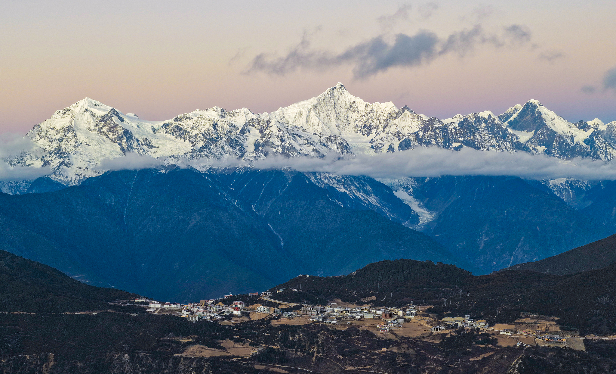 Sunlit golden peaks: Meili Snow Mountain in winter
