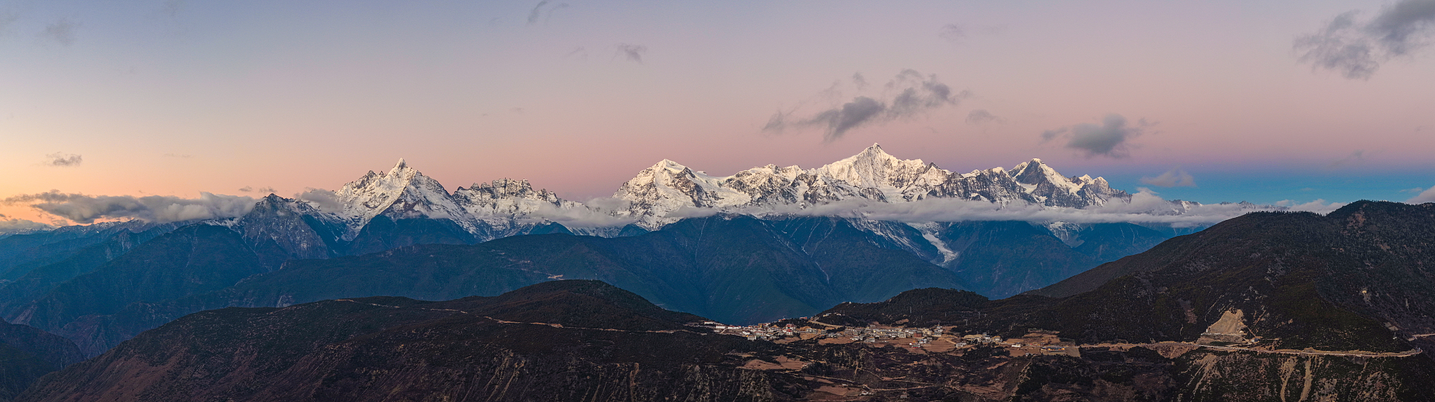 Sunlit golden peaks: Meili Snow Mountain in winter