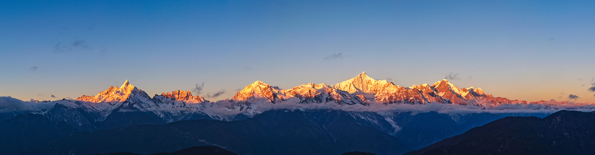 Sunlit golden peaks: Meili Snow Mountain in winter