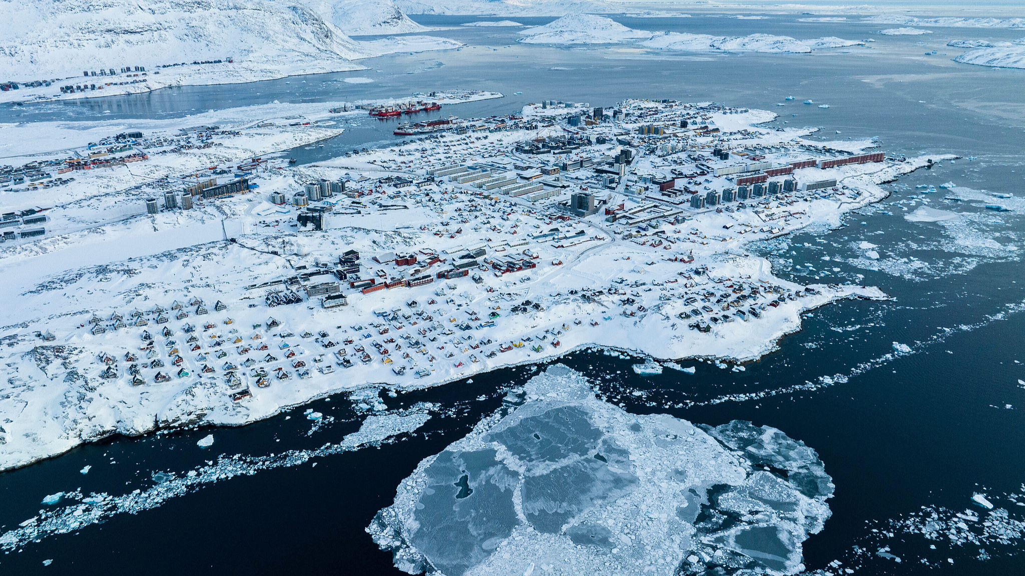 Houses covered by snow are seen on the coast of a sea inlet of Nuuk, Greenland, March 7, 2025. /VCG