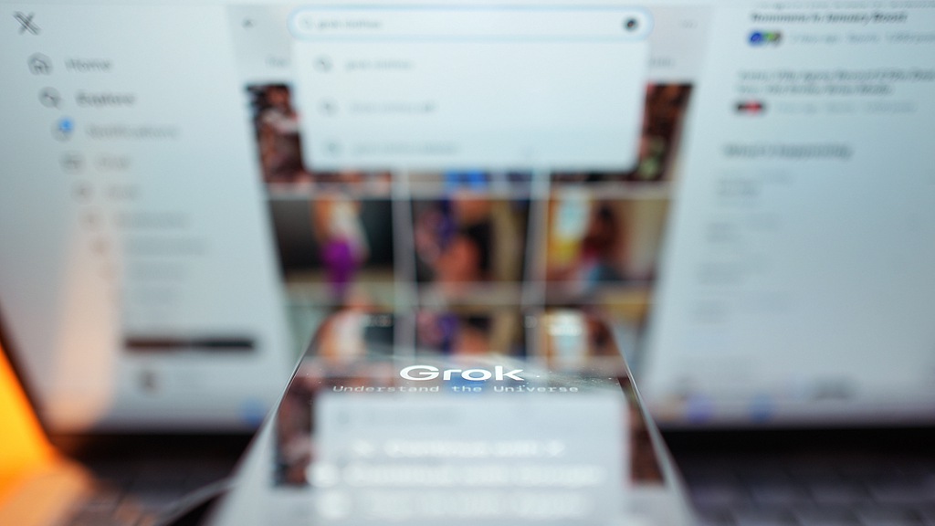 The Grok app against the backdrop of search results displayed on the social media platform X. /VCG