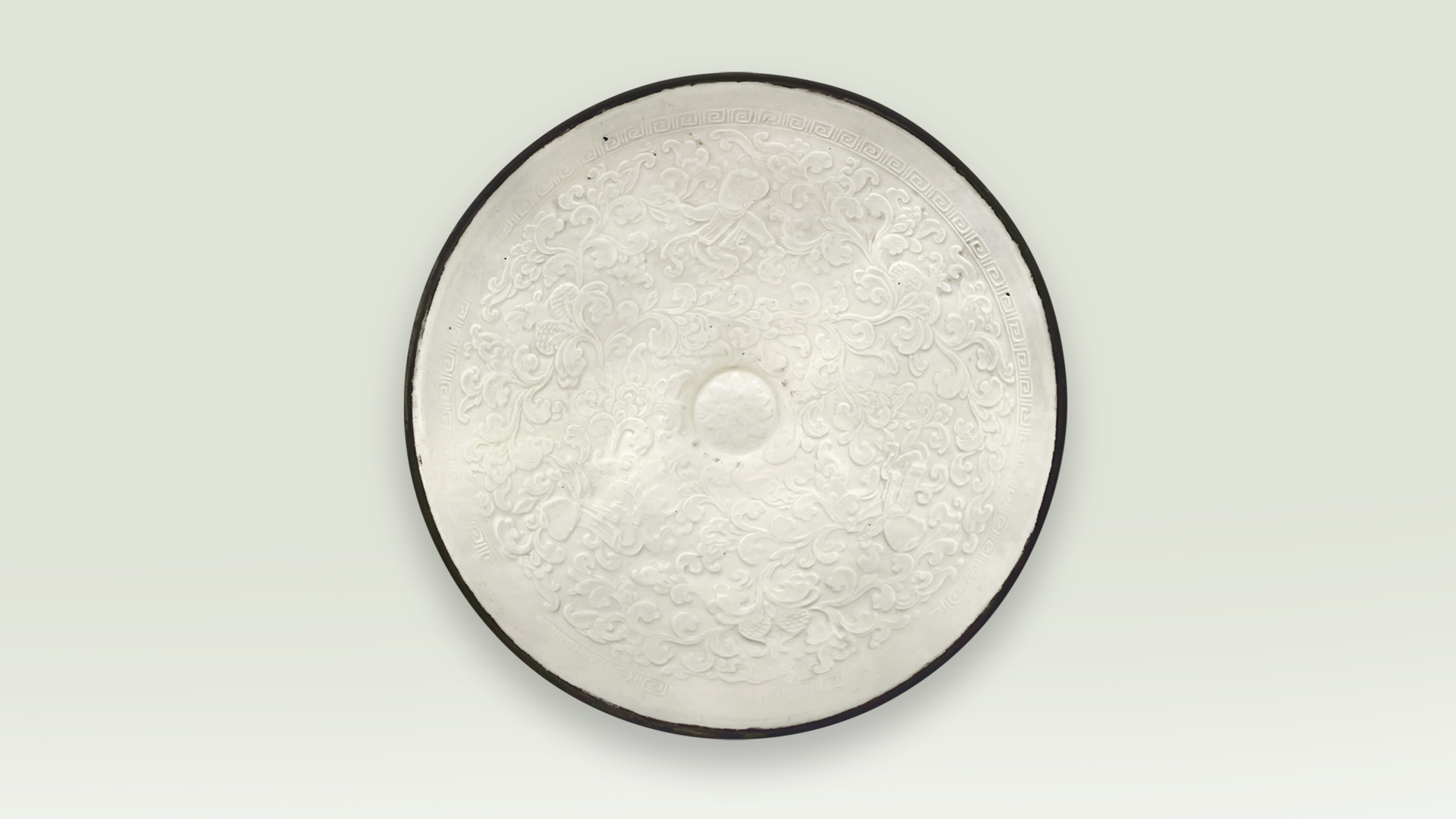 A screenshot from the virtual exhibition showing a conical bowl with impressed decoration of children and a pomegranate in white glaze. /CGTN